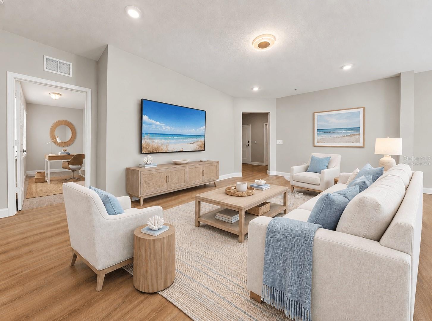 Virtually staged living room with view of den/office