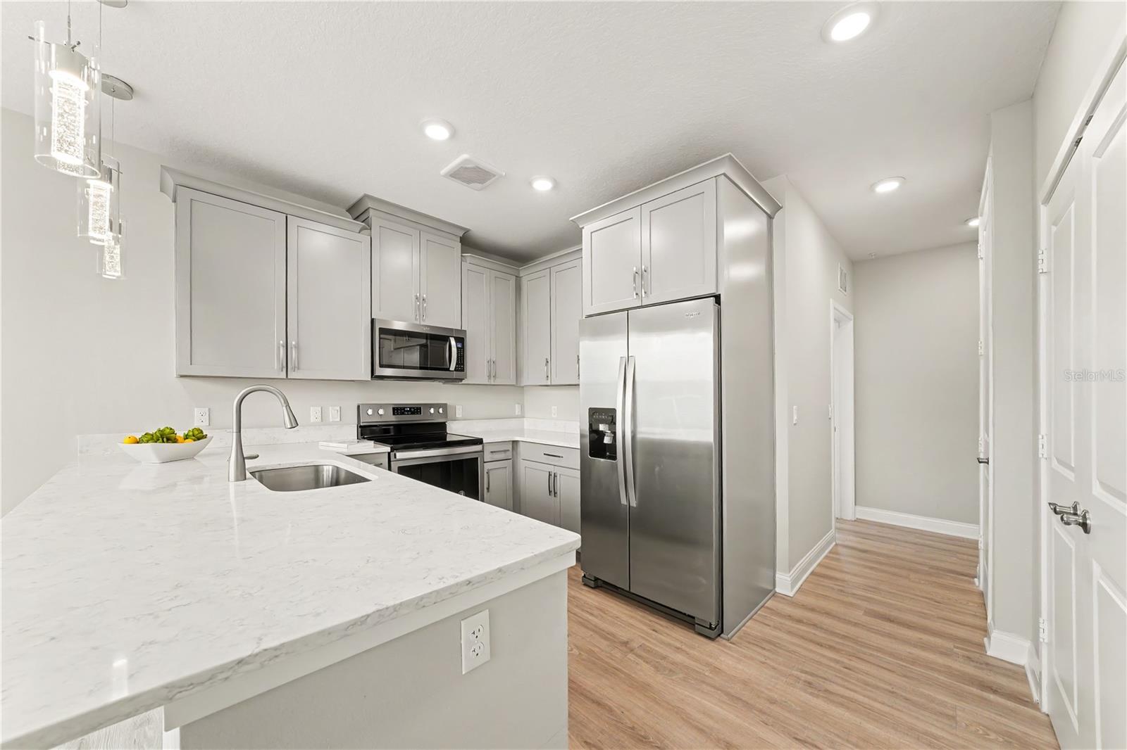 An enviable kitchen with pantry and plenty of cabinets (also with pull out shelving)
