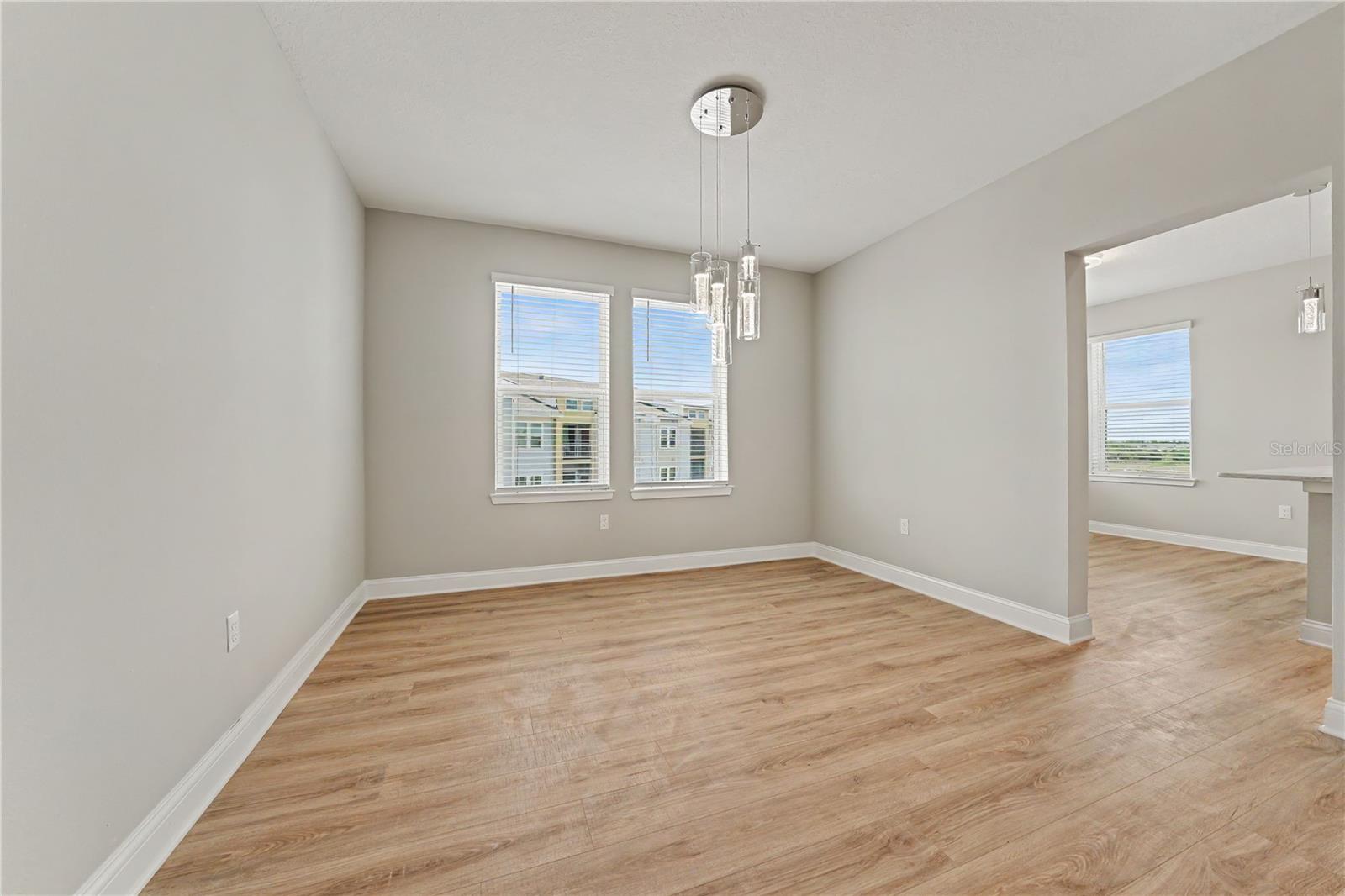 Separate dining room with stunning chandelier, adjacent to kitchen and great room.
