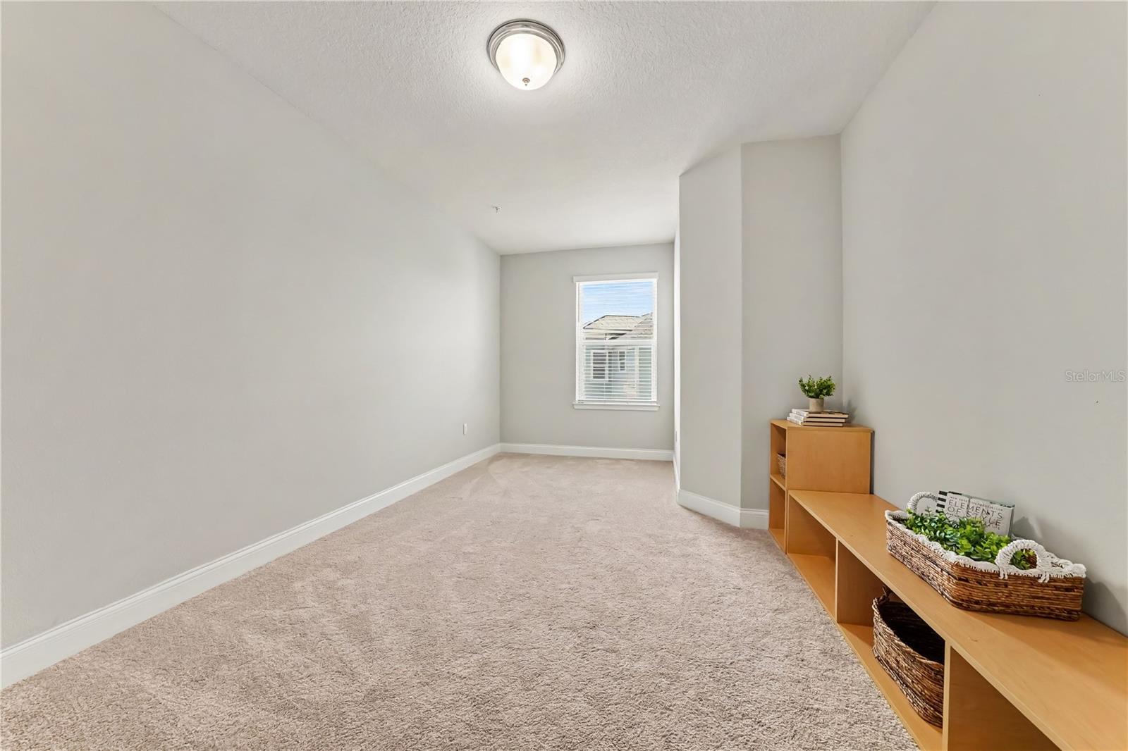 Bedroom #3 with built in bookcase/media center, closet, and window
