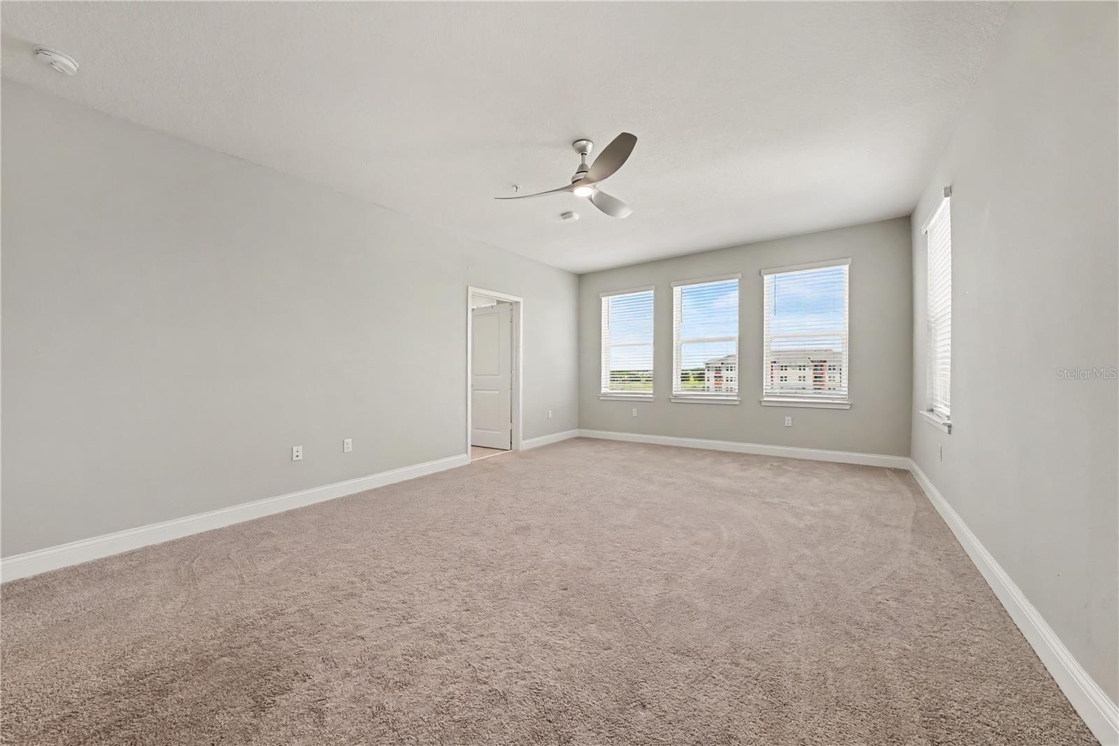 Huge primary ensuite bedroom with views of the pool and Clubhouse.  Just walk across the street and you'll enjoy the many amenities The Gathering offers.  Prime location!