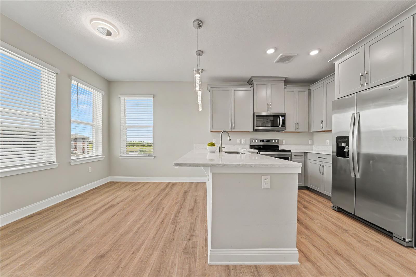 Eat in space in the kitchen with counter height bar and 4 windows streaming Florida sunshine and breezes!