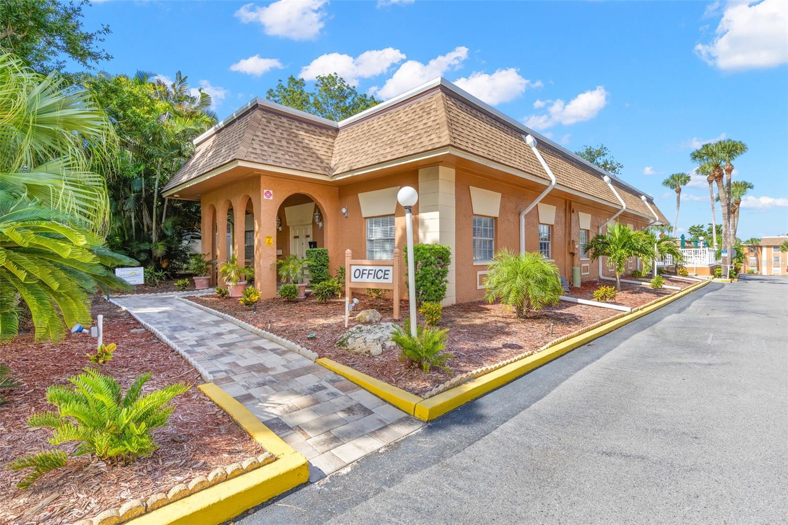 Within the community, the on-site office is surrounded by tropical landscaping and a paved walkway, adding another convenient touch to the New Atlantis Club setting.