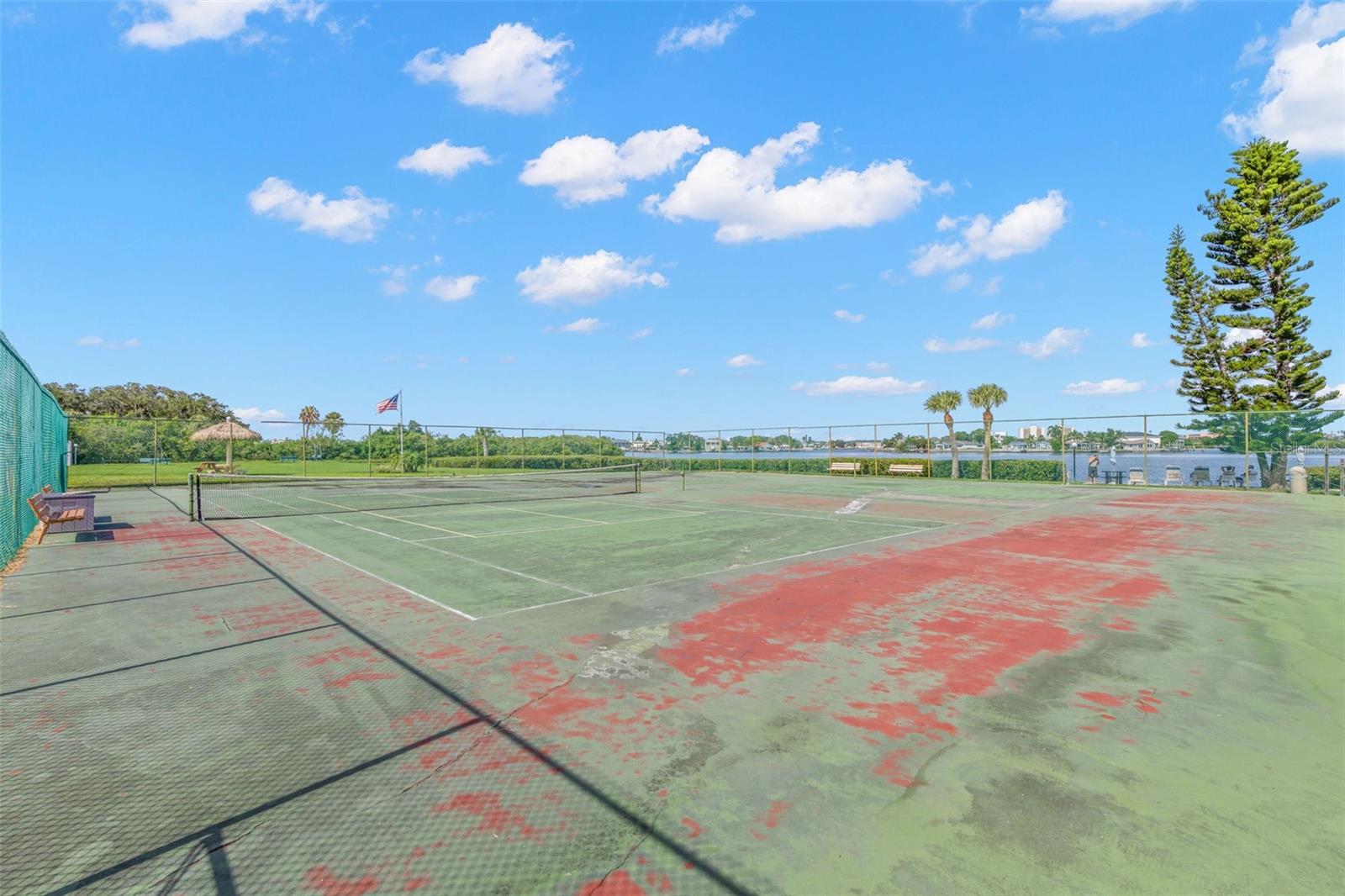 The community tennis courts sit beside the water, pairing another recreational amenity with open views across the surrounding mangroves and Intracoastal setting.