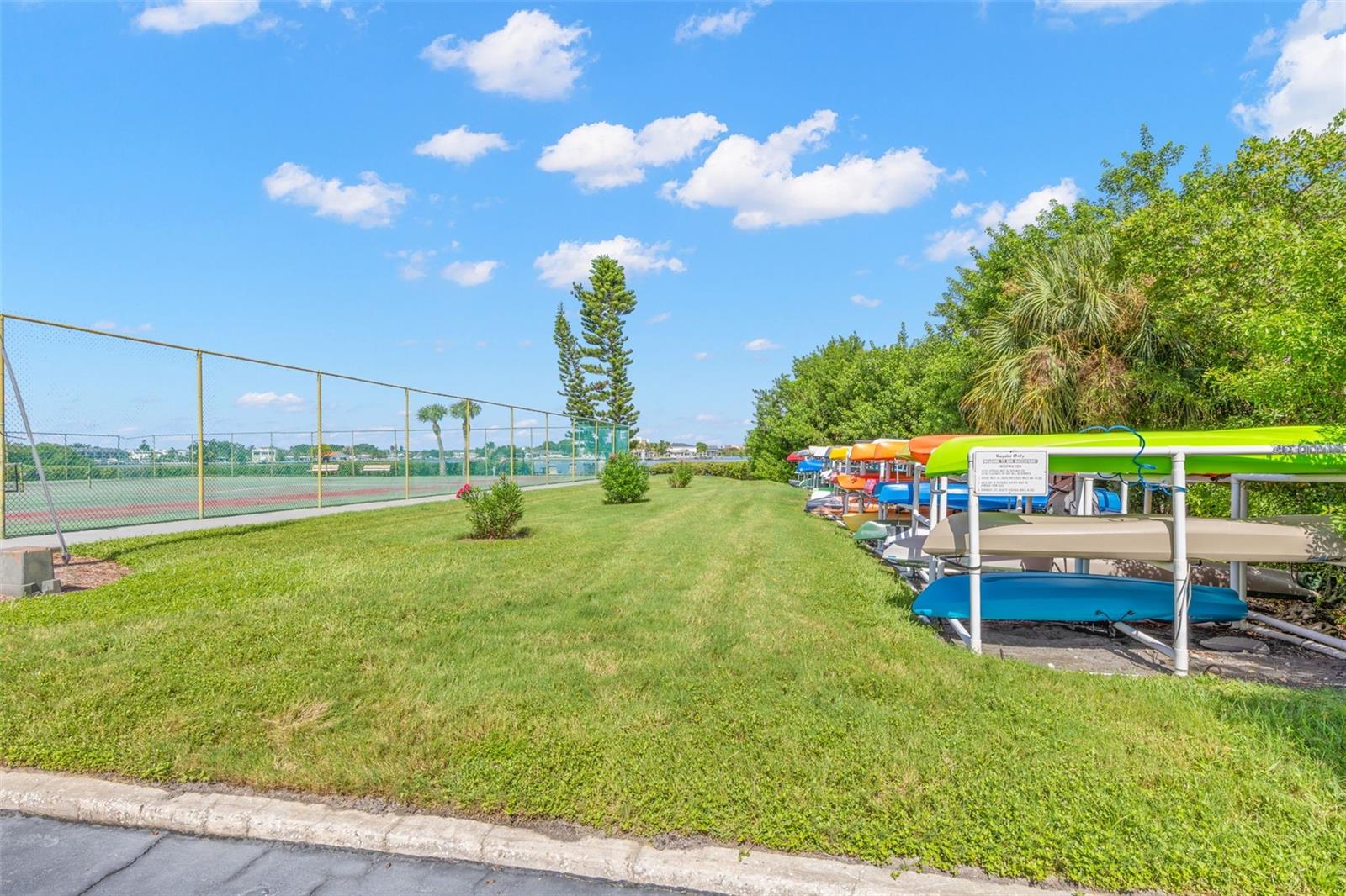 Outdoor amenities continue with tennis courts alongside dedicated kayak storage, adding another recreational option within the New Atlantis Club community.