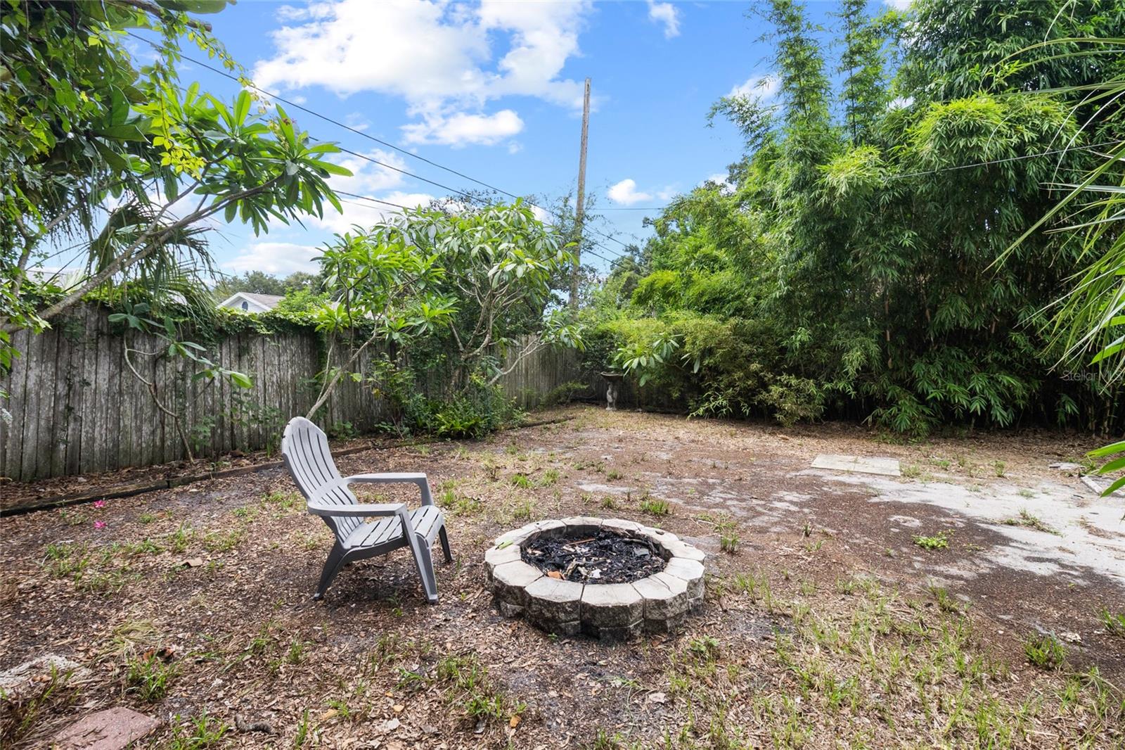 spacious fenced yard with firepit!