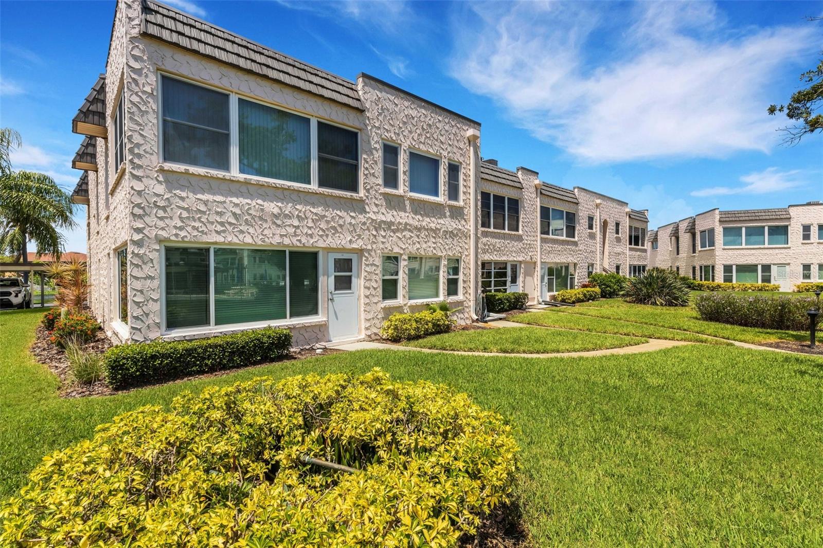 Rear of Unit with Pedestrian Door and Walkway to pool and Clubhouse