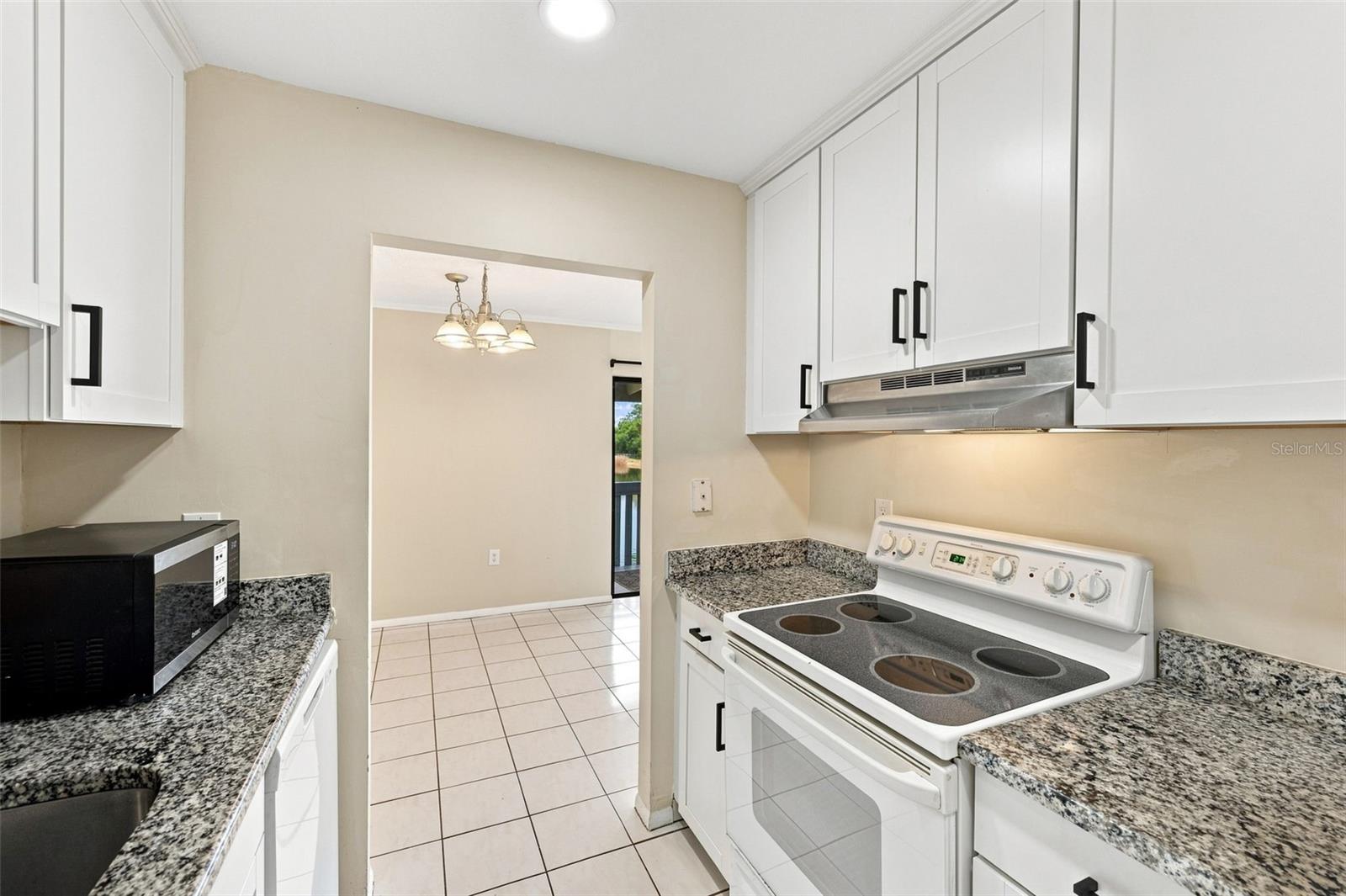 Galley Kitchen with Granite Countertops.