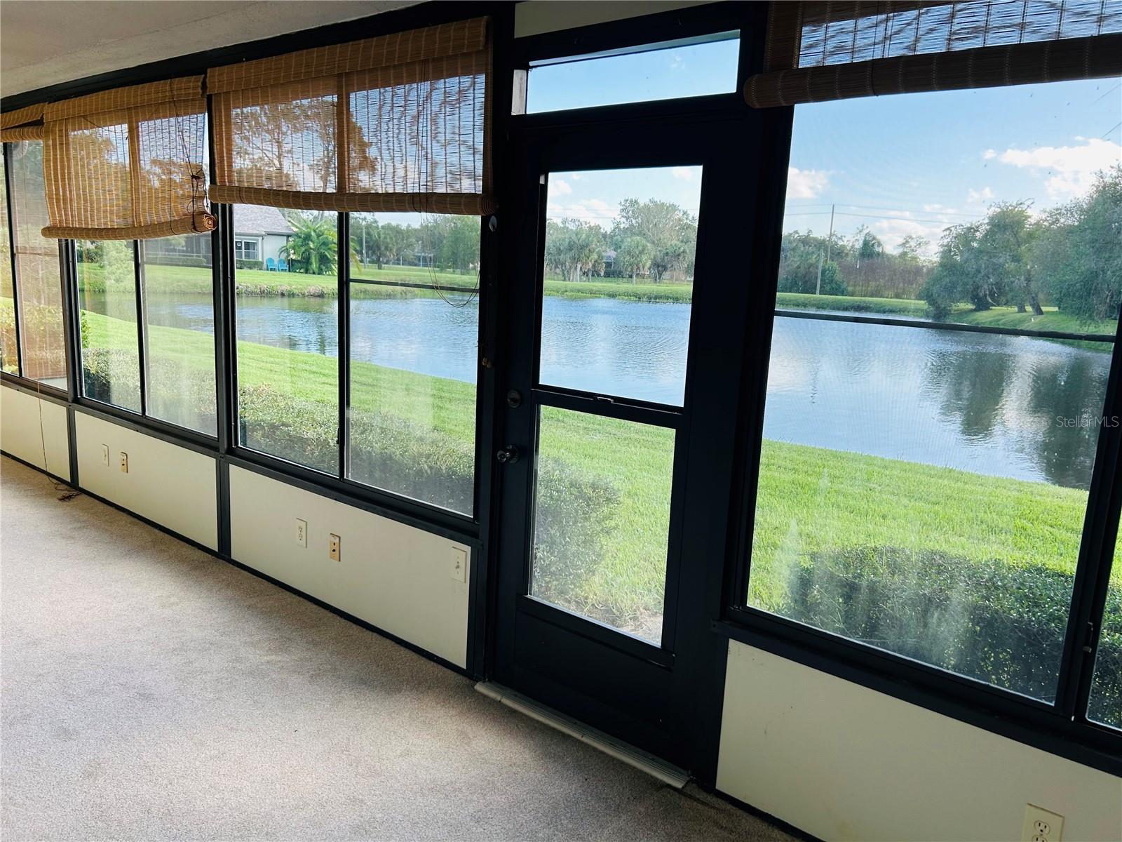 Large enclosed florida room overlooking the pond