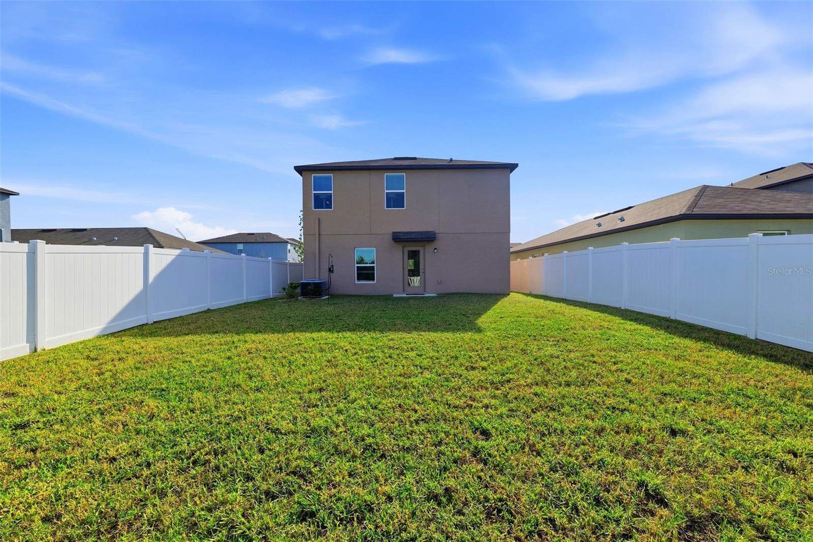 Large backyard with new vinyl fencing