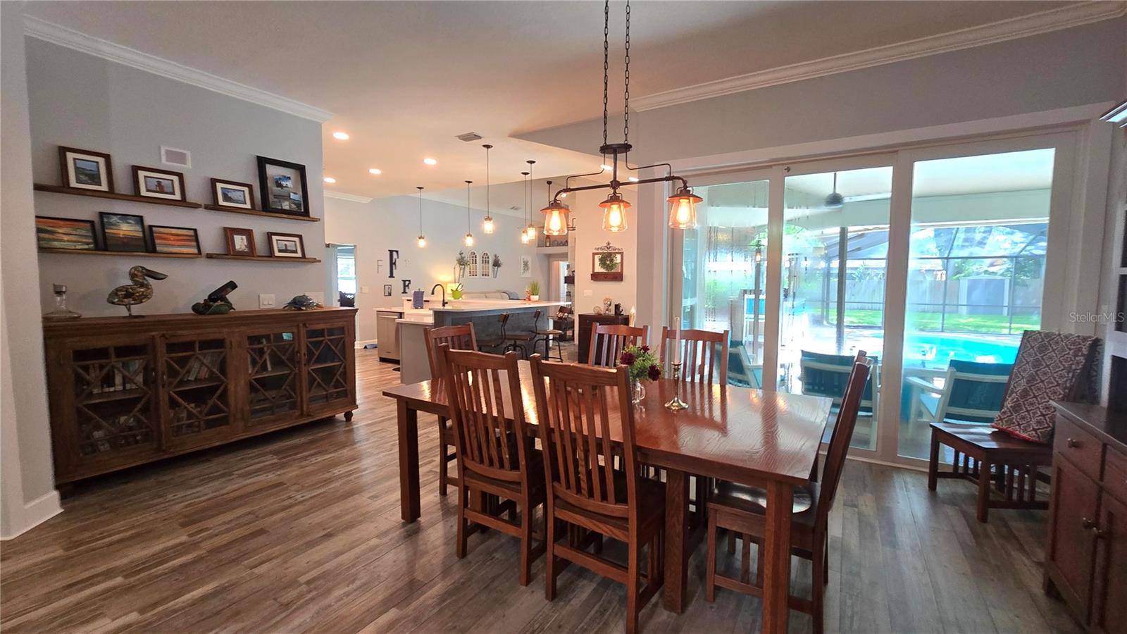 Lovely view from the dining room to the inviting pool area through the sliding glass doors. Lovely view from the dining room to the inviting pool area through the sliding glass doors.