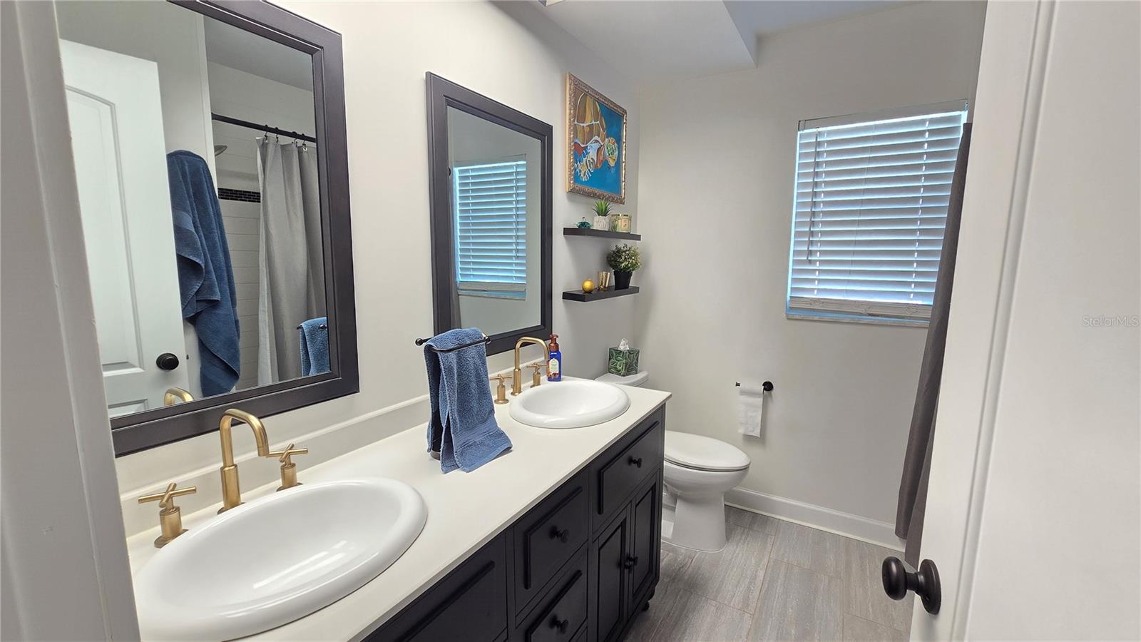 Full bathroom with shower/tub combo plus double sinks.