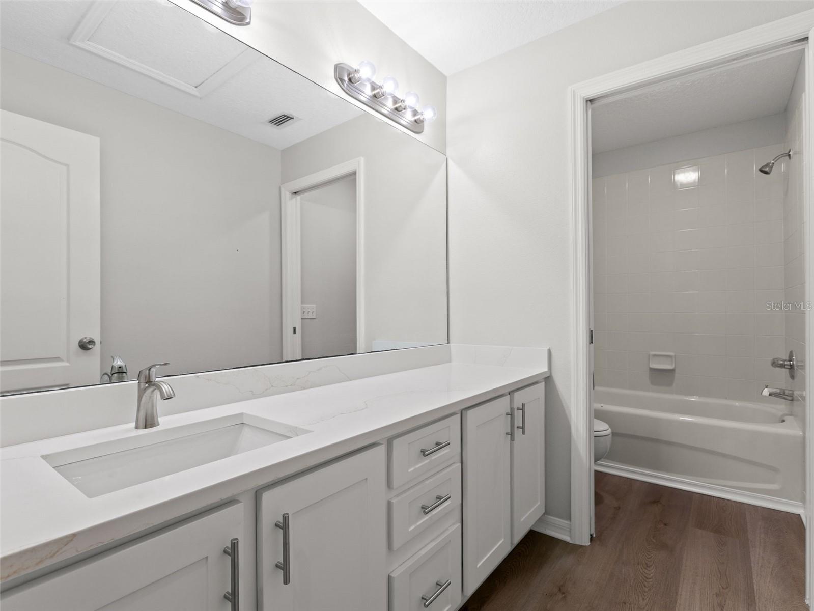 Upstairs bathroom with separate tub and toilet room attached