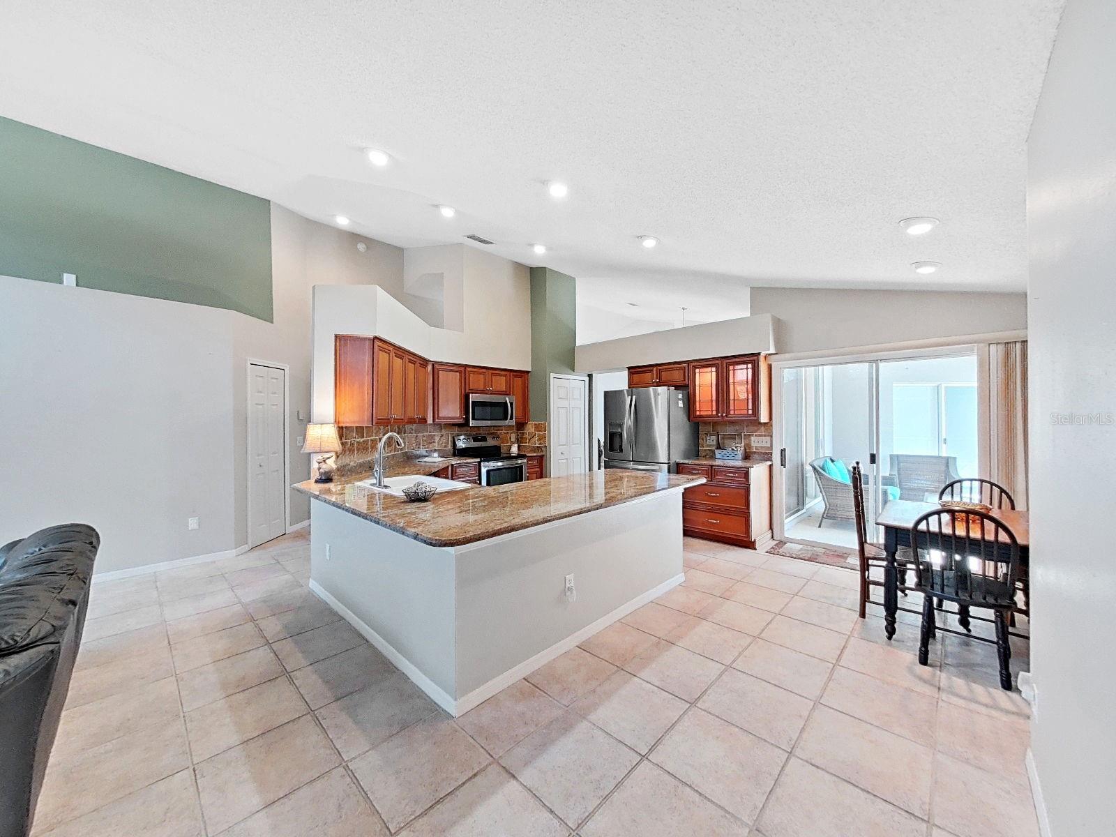 updated kitchen with granite countertops, stainless appliances, recessed lighting