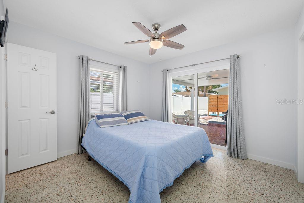 Primary Bedroom with En-Suite Bathroom to the Left and Sliding Glass Door access to Lanai