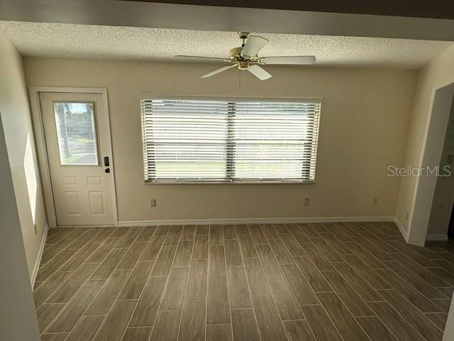 Enclosed lanai with door to the back yard.  Morning sun is beautiful in this room, a great place for that morning cup.