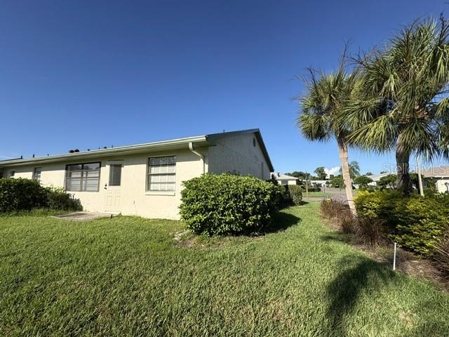 Back of home, pretty Florida landscaping features on this corner lot.
