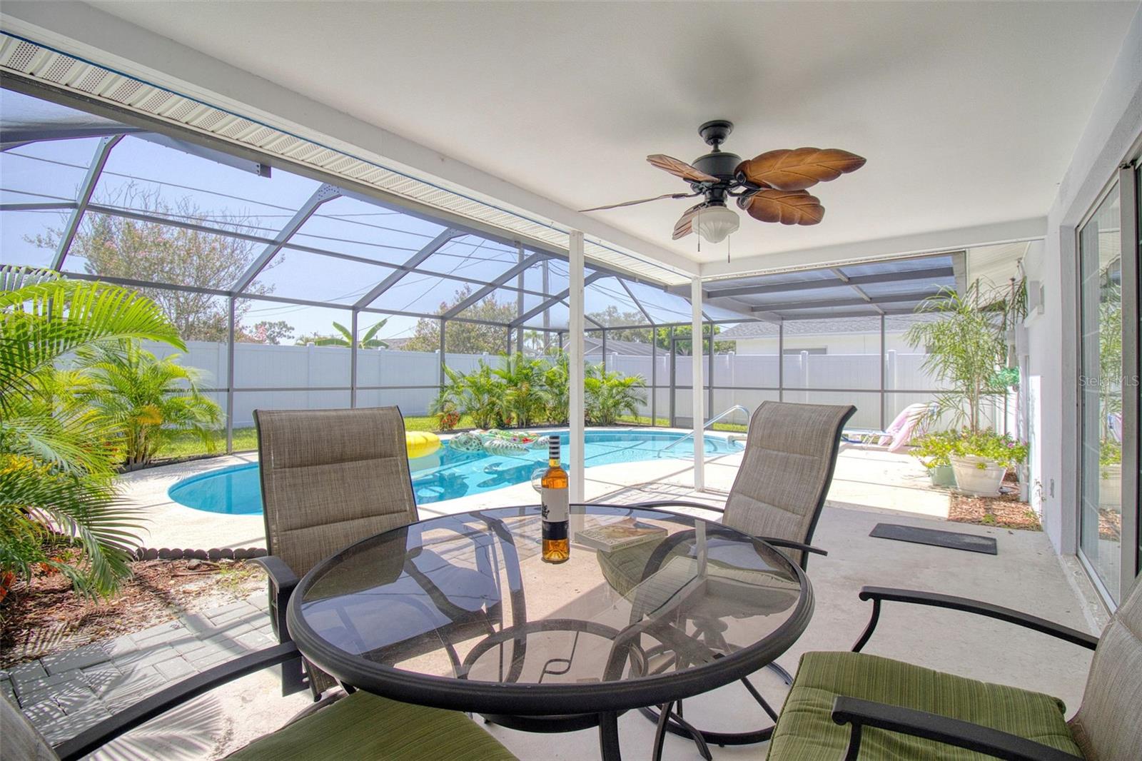 Covered and screened in patio beside pool