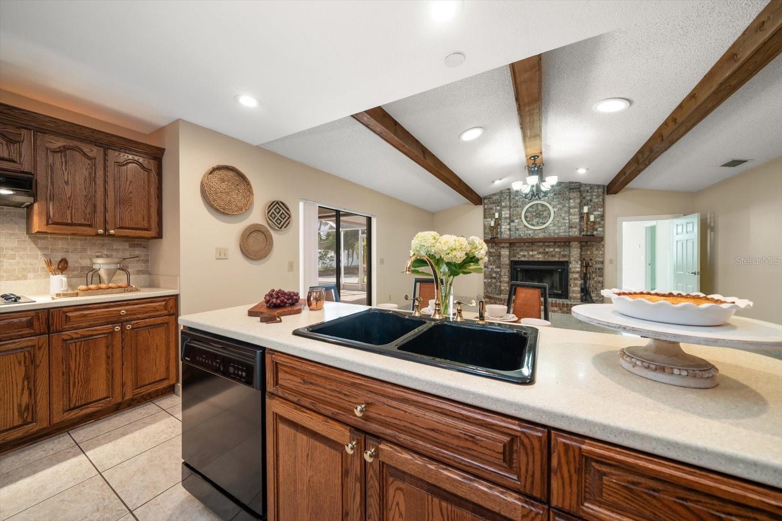 Warm and inviting great room with kitchen, eating and family room with masonry fireplace and beamed ceiling!