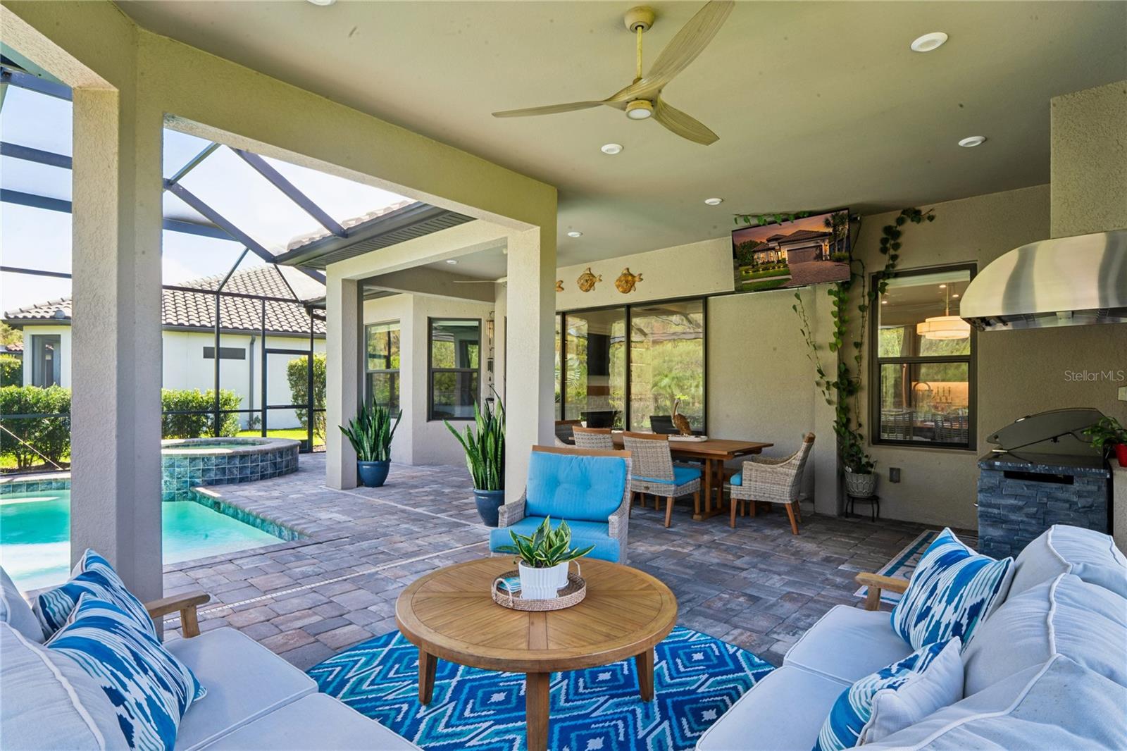 Outdoor Living space w/ Pool lanai, outdoor kitchen & dining