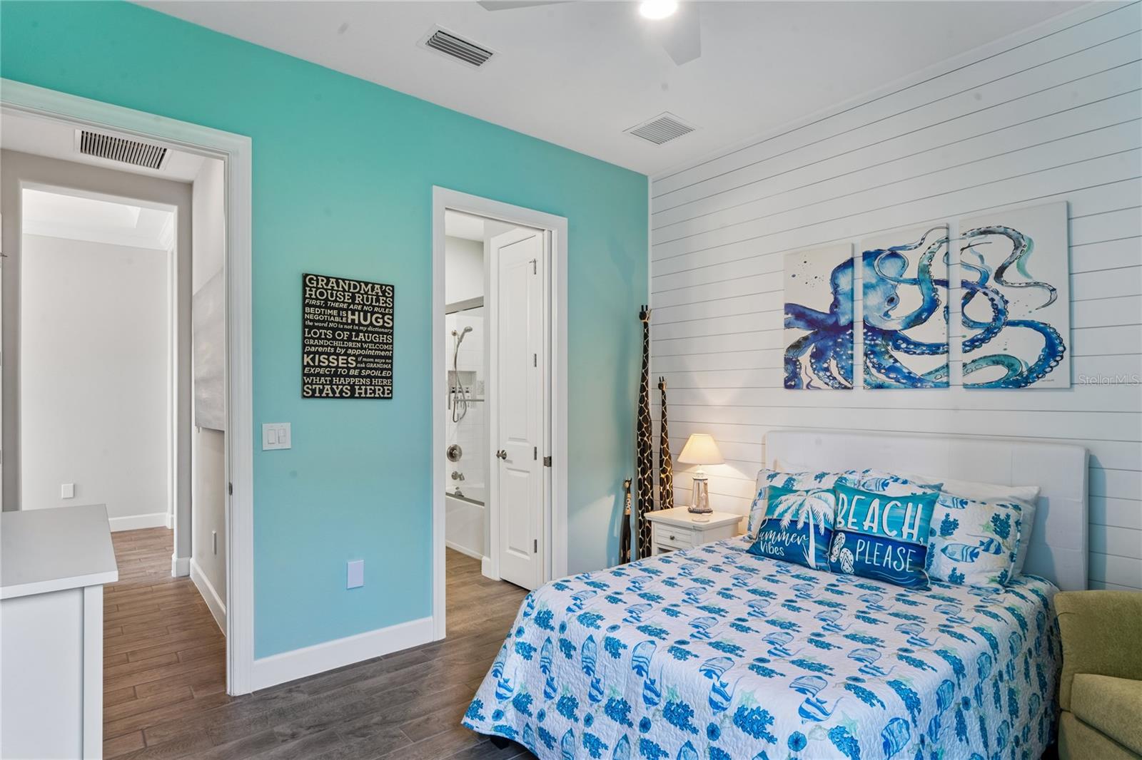 Bedroom 3 w/ en-suite bathroom and shiplap wall feature