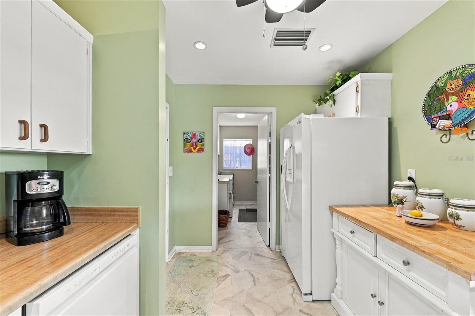The kitchen feeds right into the inside laundry/storage room.