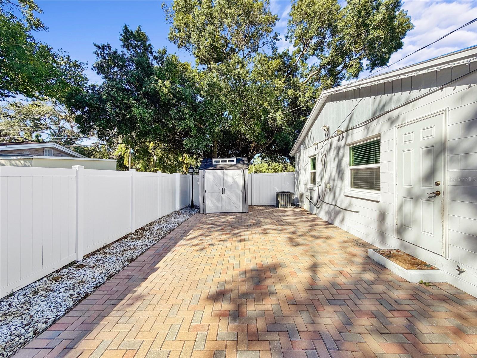 Back paver patio with shed
