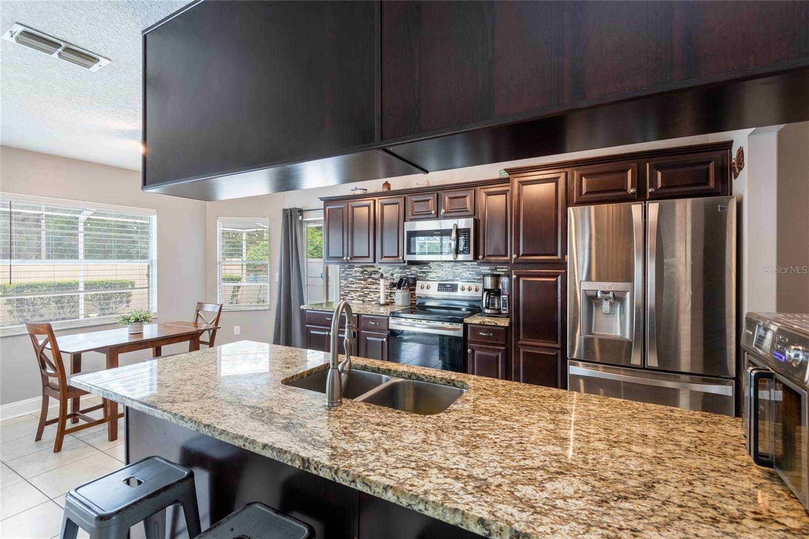 Kitchen and dinette with granite counter tops and wood cabints.