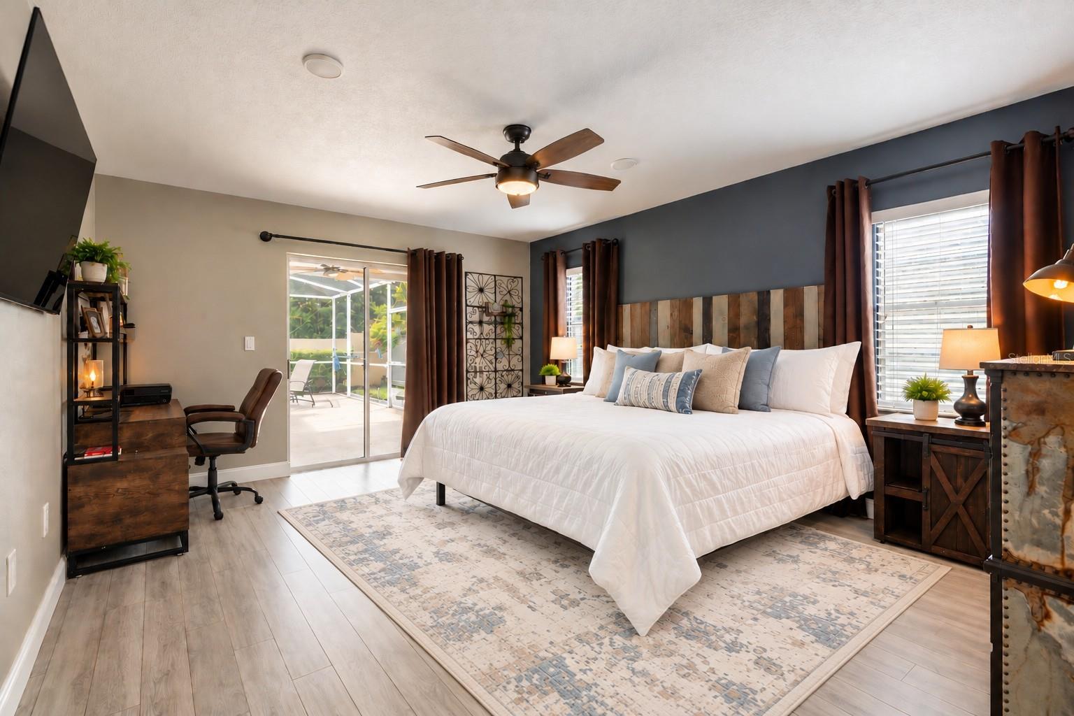 Spacious primary suite with sliders leading to a private covered patio area.