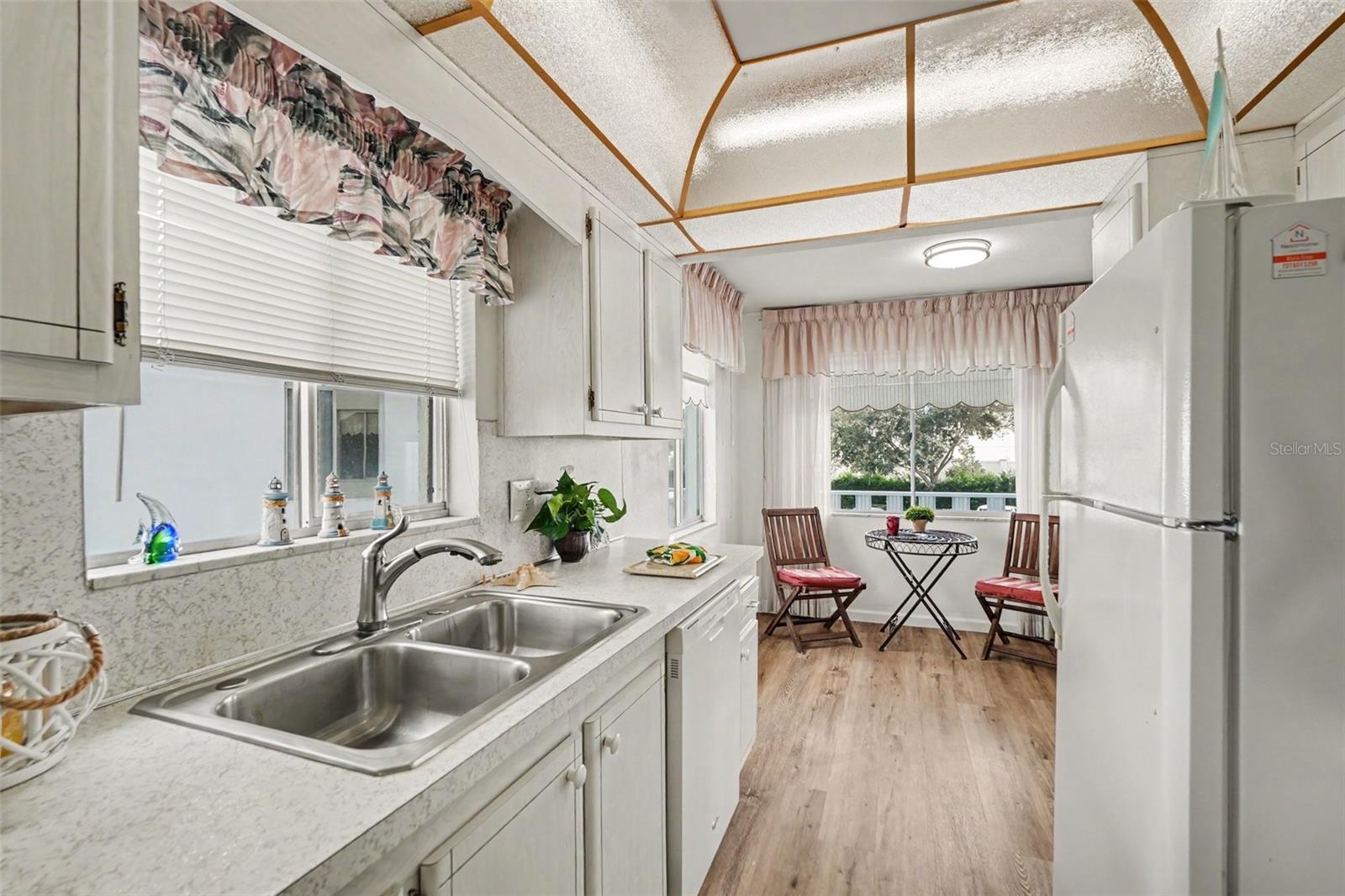 Super cute kitchen has lots of natural light and a view from the sink of the lovely pond with waterfall!