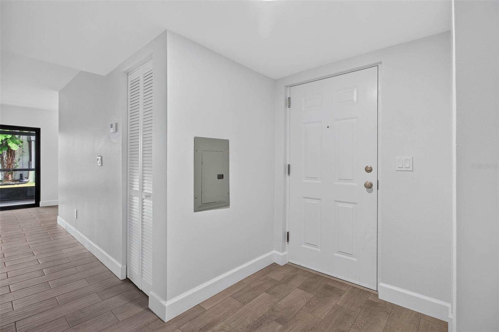 Foyer with new front door and newer electrical panel Foyer with new front door and newer electrical panel