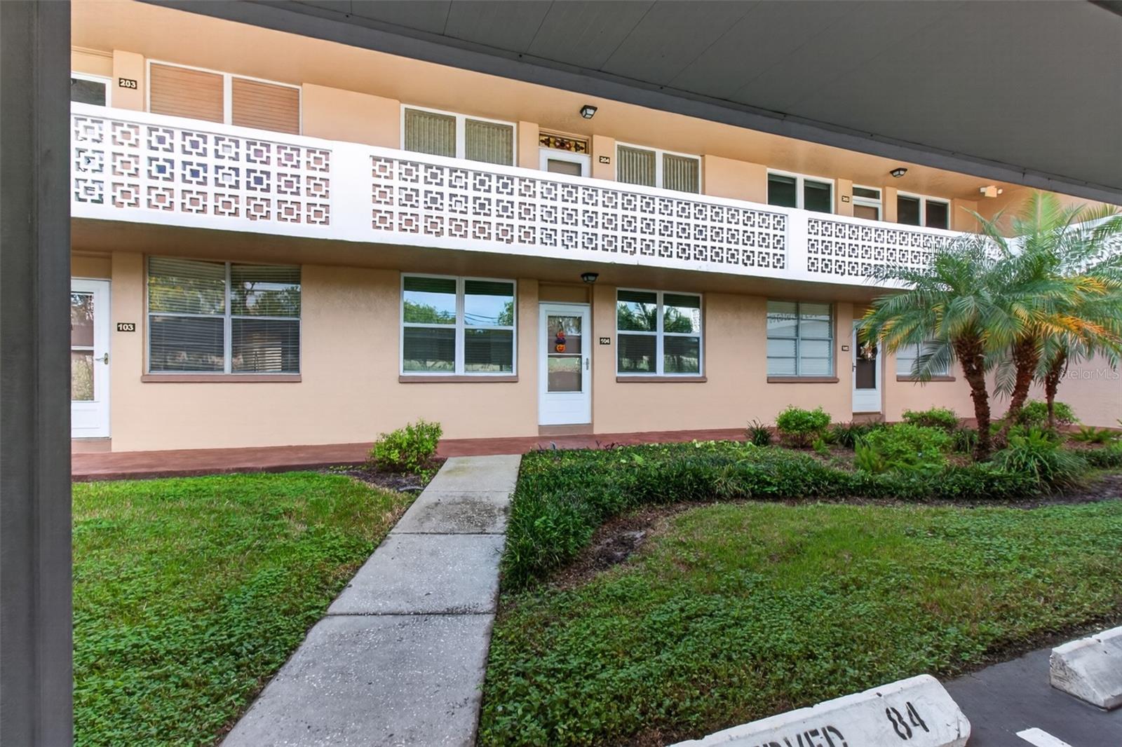 Front walkway from your covered deeded parking space #84 in front of the unit.