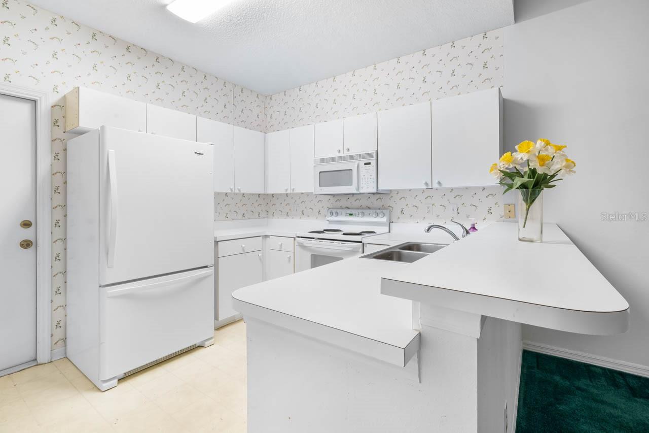 Kitchen with door leading to the garage