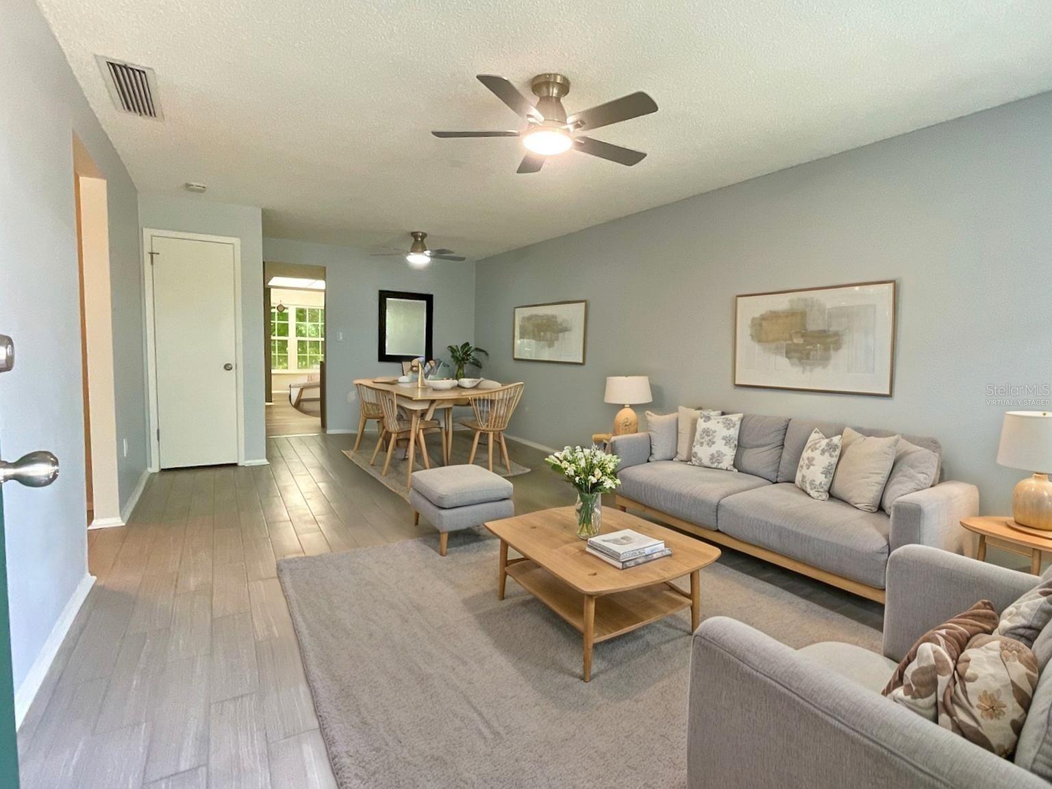 Virtually staged-living room and dining area.