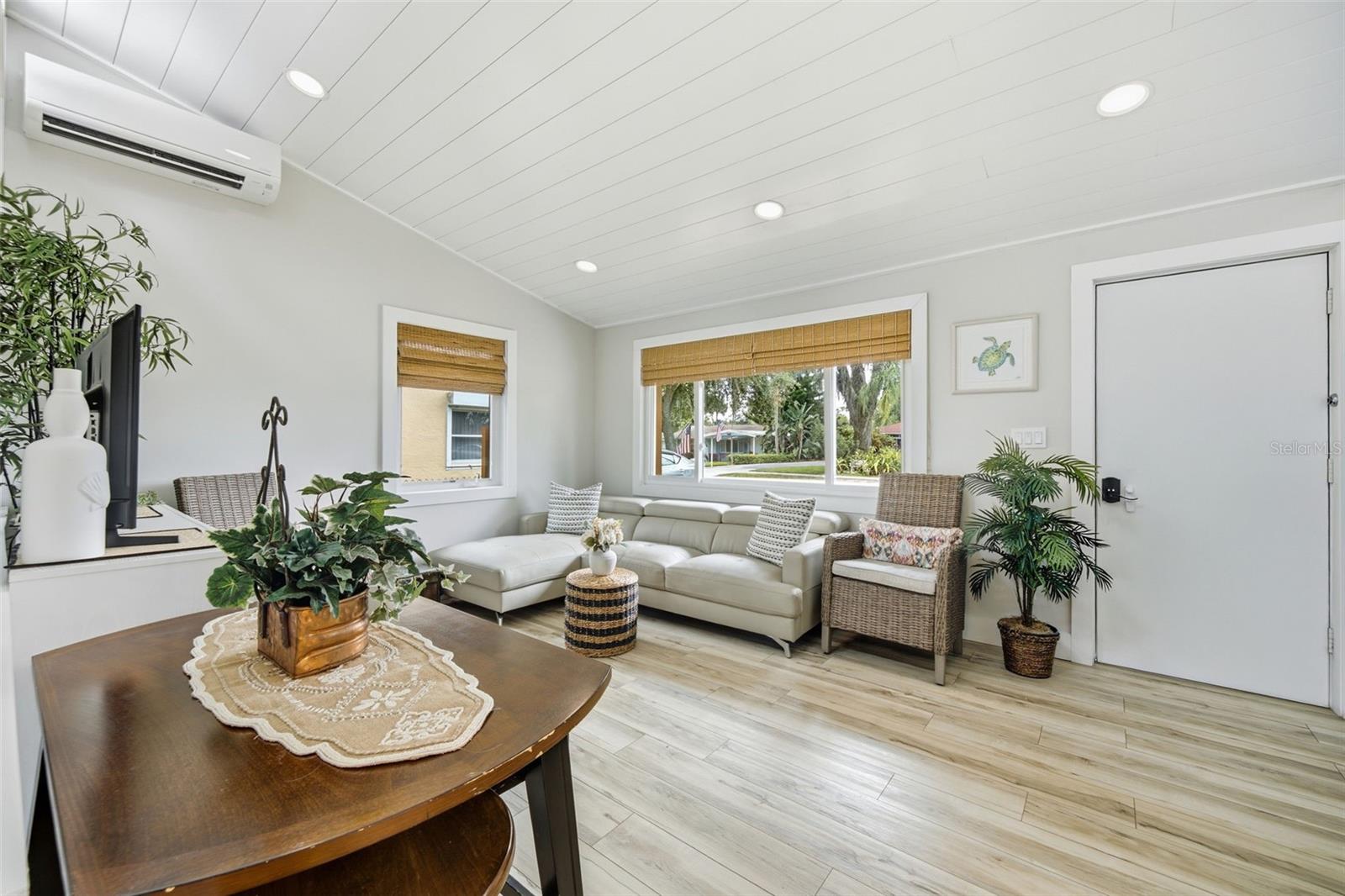 Impact-resistant windows complemented by warm woven wood shades