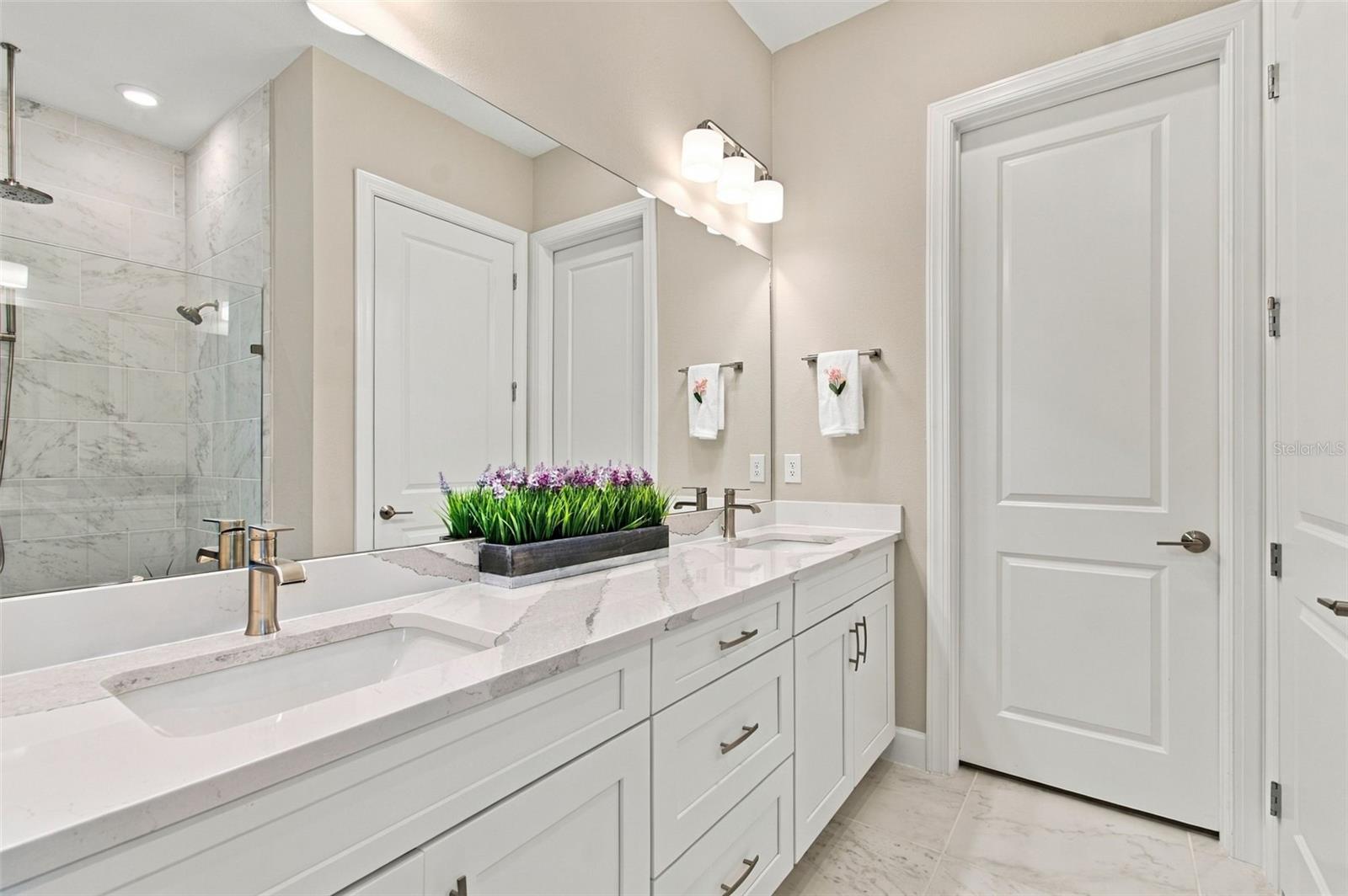 Primary Bathroom with double vanity, huge walk-in shower with 3 different shower head options, private water closet and spacious closet