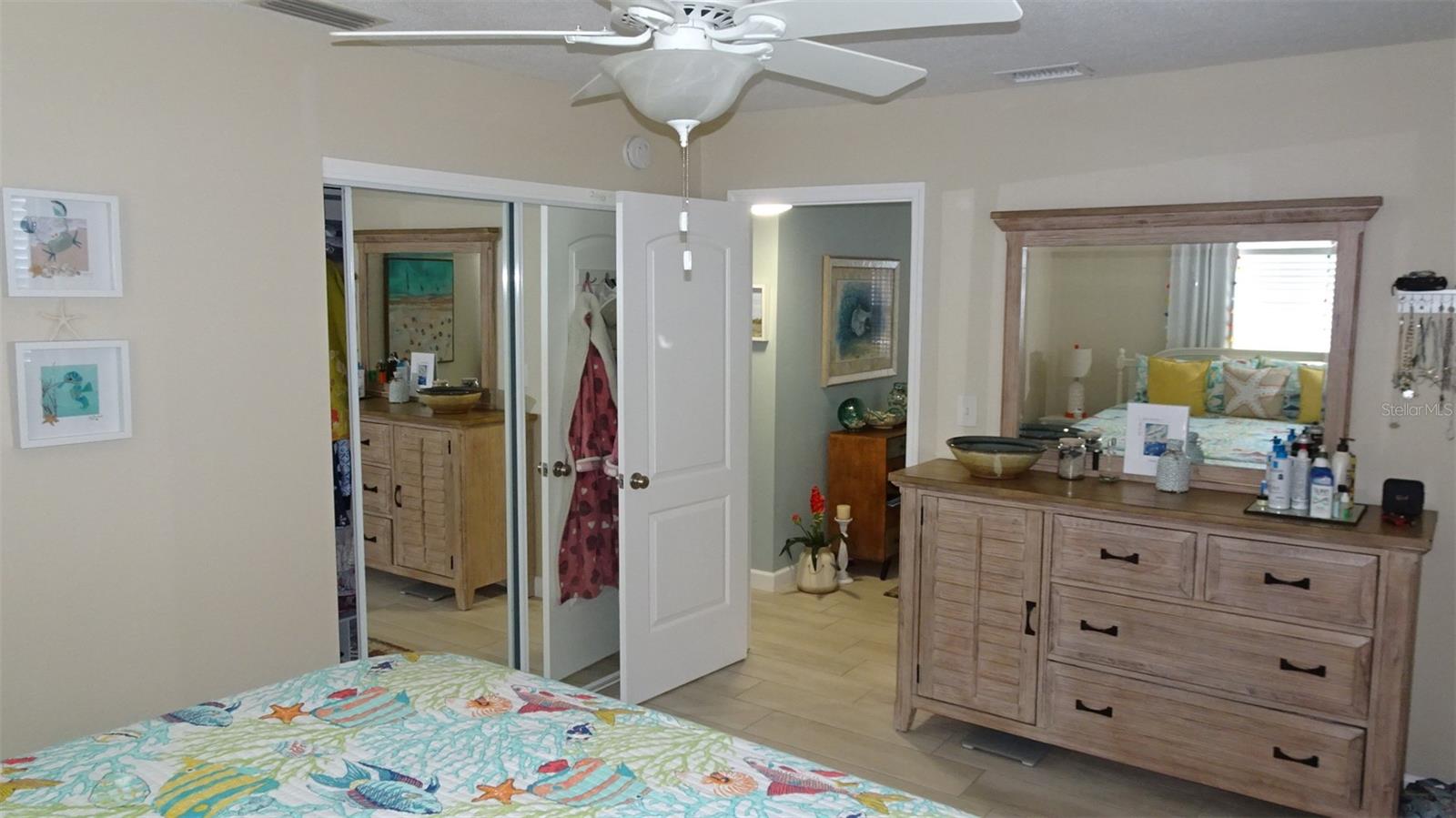 Front bedroom as furnished, mirrored glass closet doors.