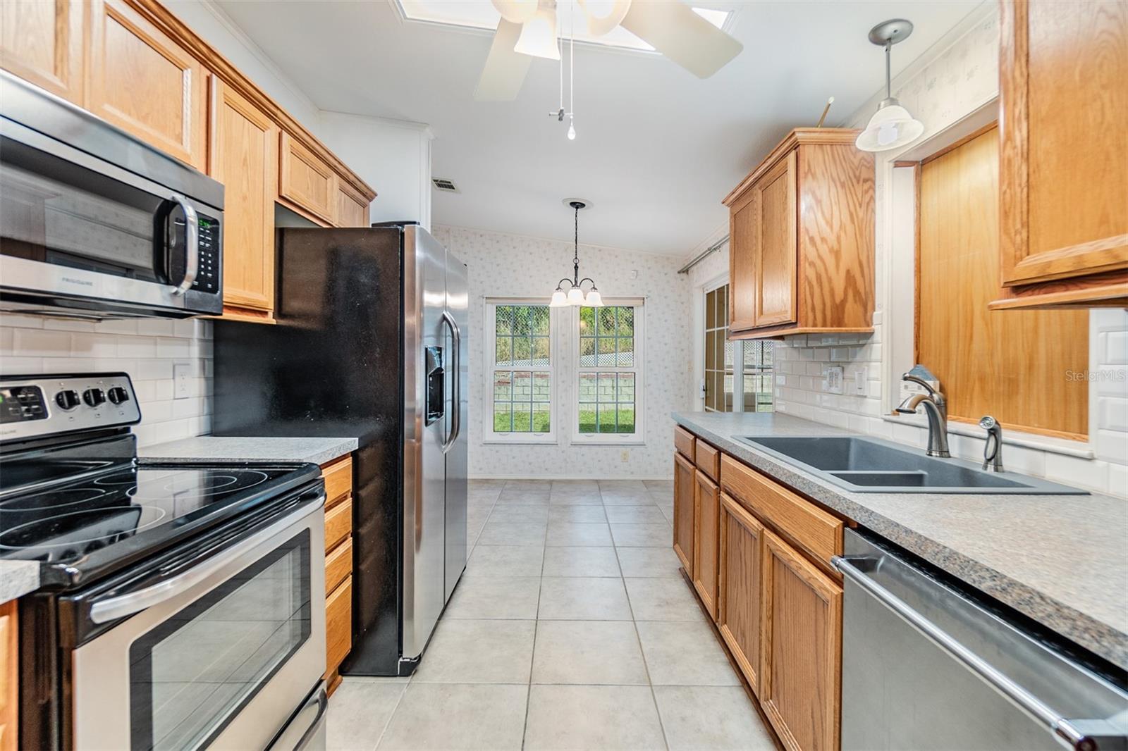 Updated kitchen with wood cabinets and stainless appliances