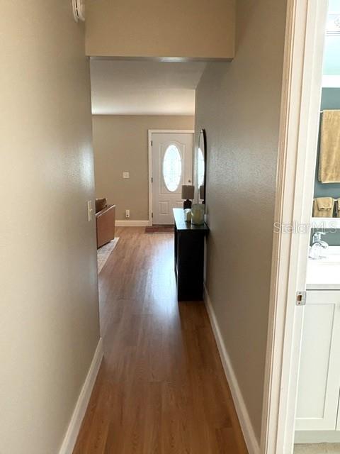 From bedroom hallway toward front door, natural light is a nice greeting through the glass insert at the front door.