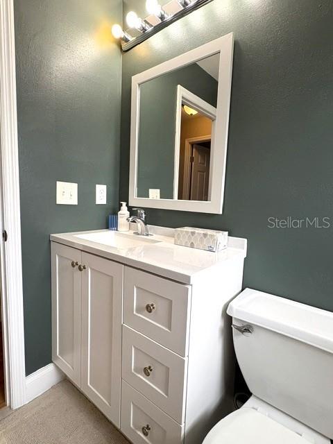 Guest bath vanity has plenty of storage room.