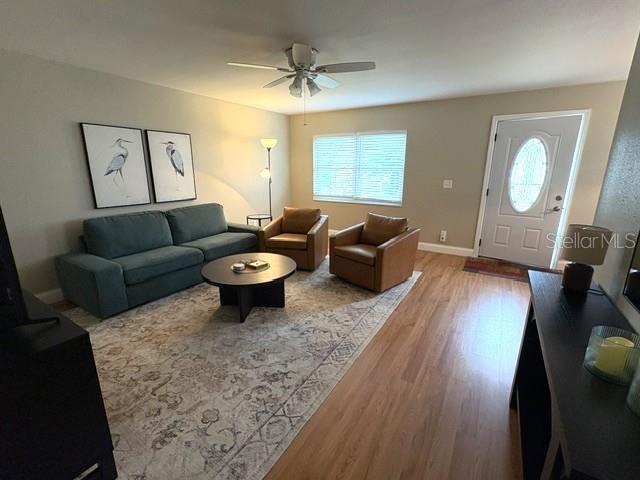 Living room is inviting, with good natural light through the glass insert at the front door.