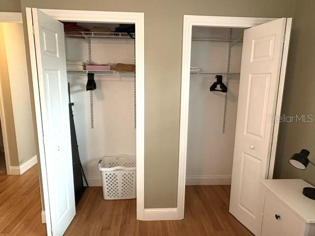 Guest room features dual reach in closets with adjustable shelving.