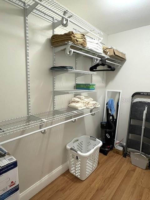 Walk in closet with adjustable shelving.