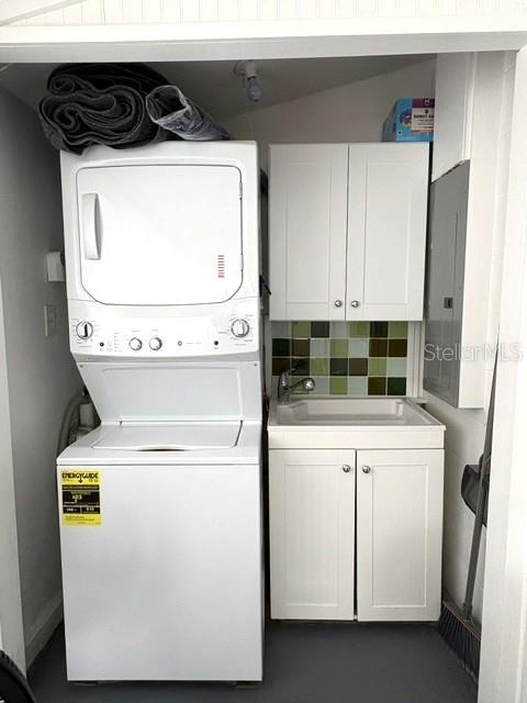 Pretty laundry area with utility sink and storage, tucked neatly in the enclosed lanai.