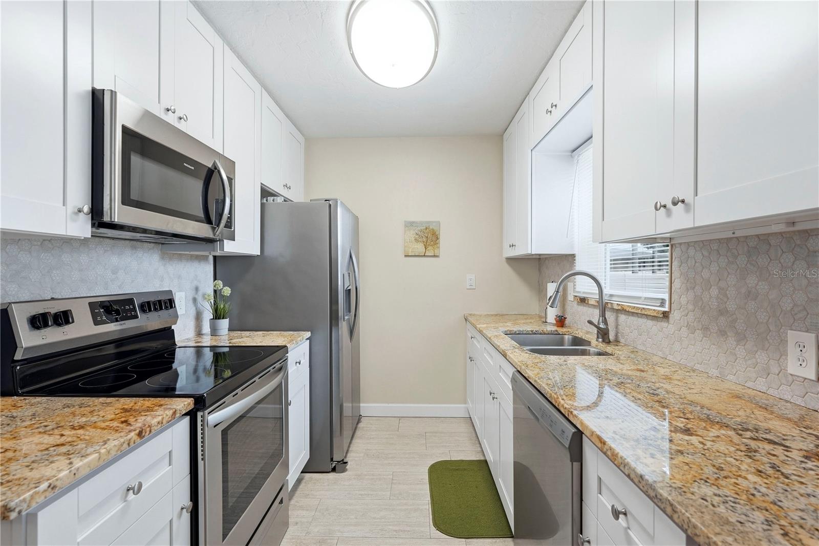Granite Counters, Shaker Cabinets, Tile Backsplash