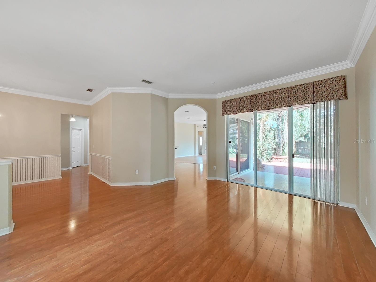 View from Living Room into Kitchen/Family Room and Doors to Lanai