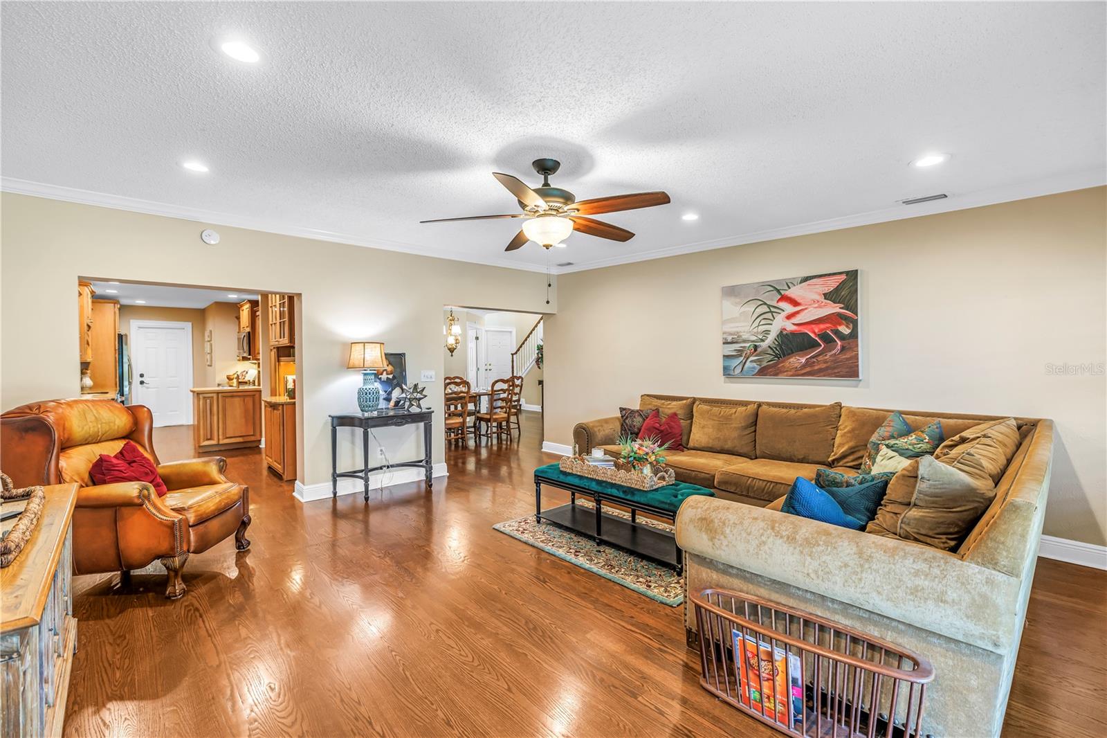 Spacious bonus family room (17x18) designed for effortless entertaining, featuring hurricane-rated sliders that offer seamless access to the screened porch and raised back patio.