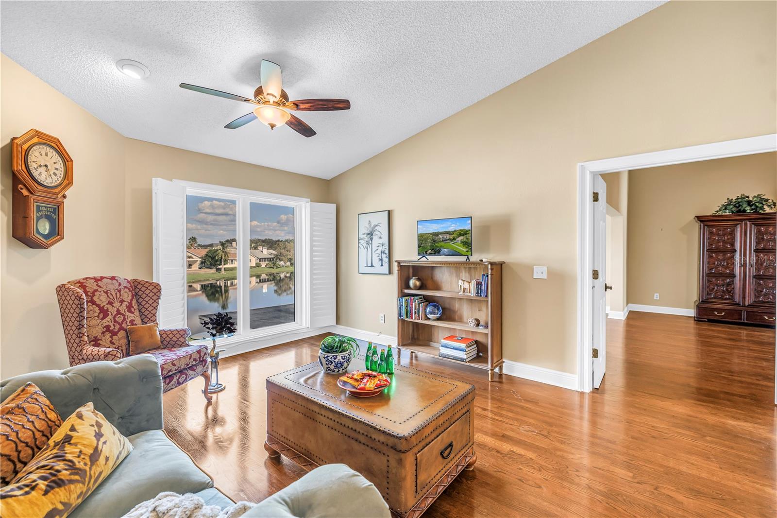This unique upstairs bonus living space in Caya Costa features vaulted ceilings and premium hardwood flooring. The room offers expansive views of the lake through floor-to-ceiling hurricane-rated windows.