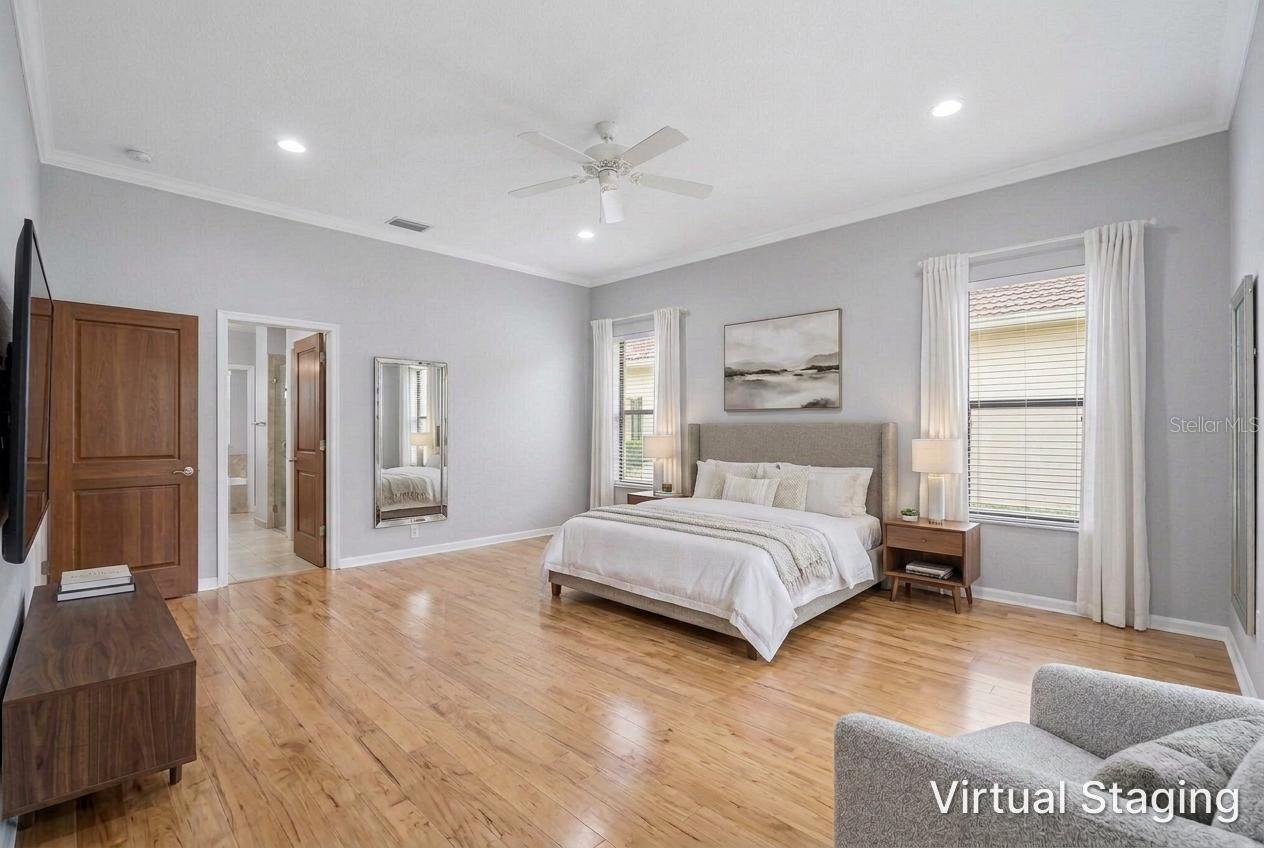 Virtual staging and updating of the previous two photos showing recessed lighting, hardwood flooring, new paint and staged furniture