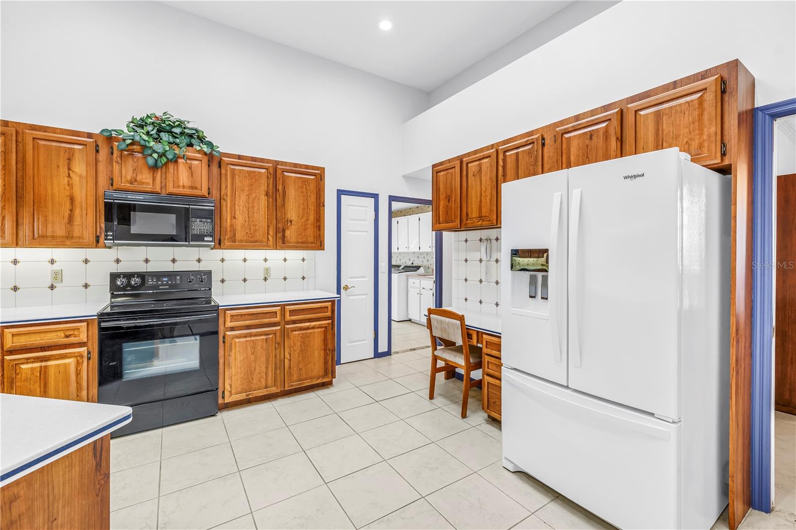 Garage access, large walk-in pantry, laundry room, all on this side of the house.  Newer refrigerator.